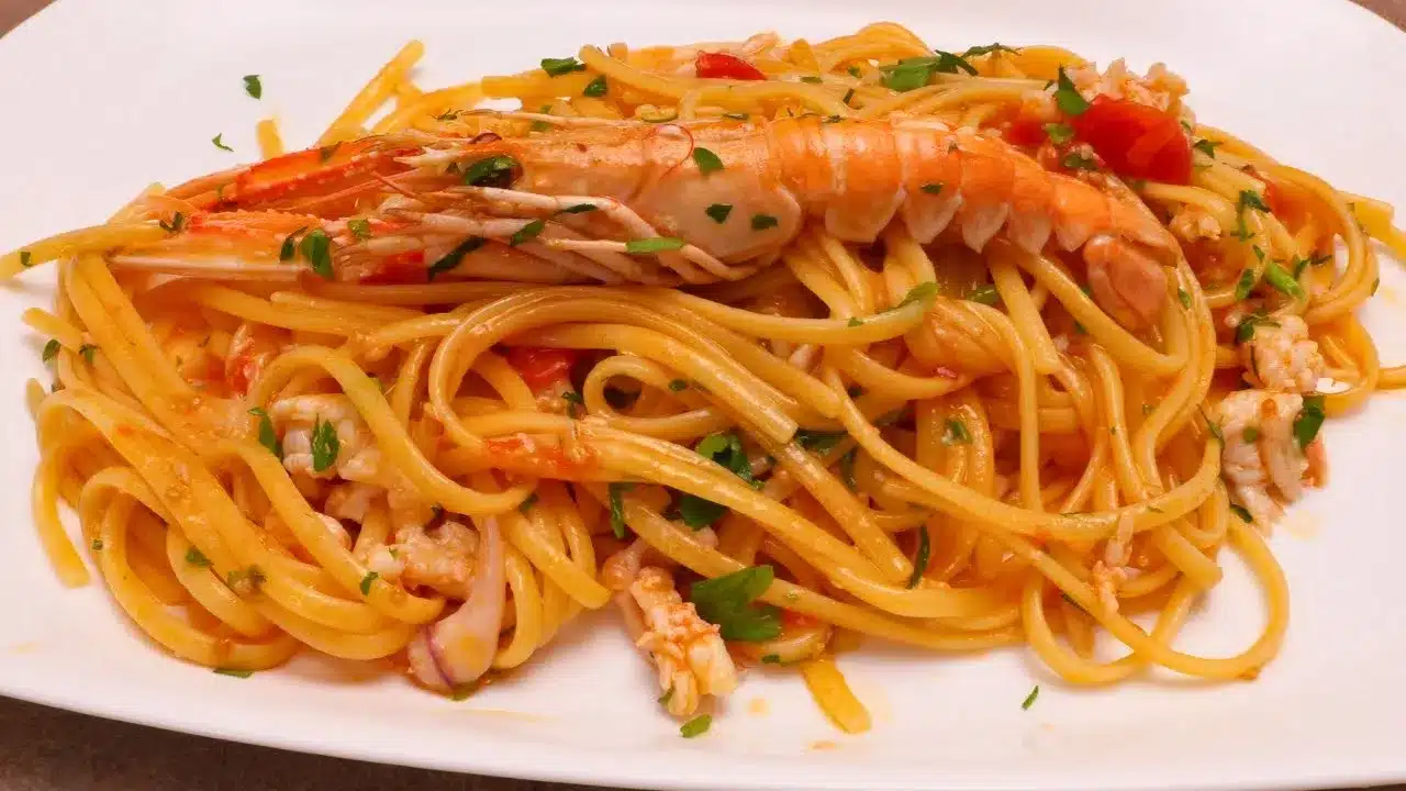 Come preparare le linguine scampi e calamari veloci: ricetta facile con pomodorini, vino bianco e prezzemolo.